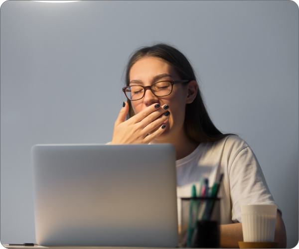 tired-secretary-yawning-working-laptop-computer-late-night